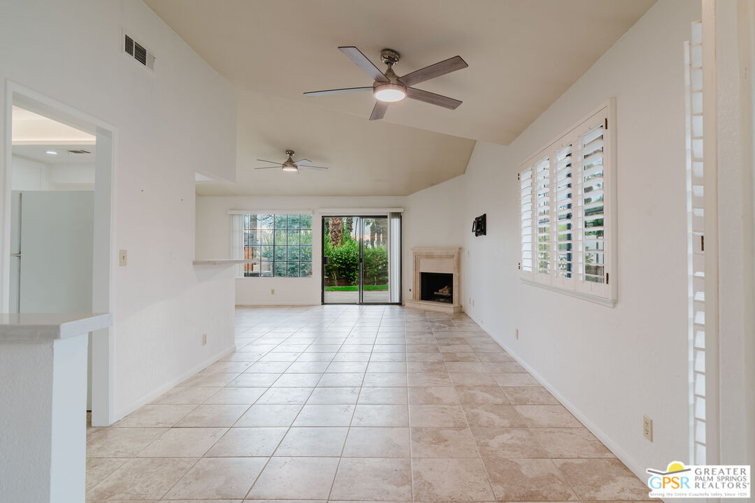 46400 Ryway Place, Unit 10 Palm Desert, CA 92260 - Photo 6 of 48 a view of an empty room with a window and a ceiling fan