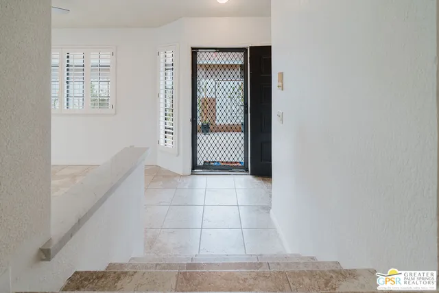 a view of an empty room with windows