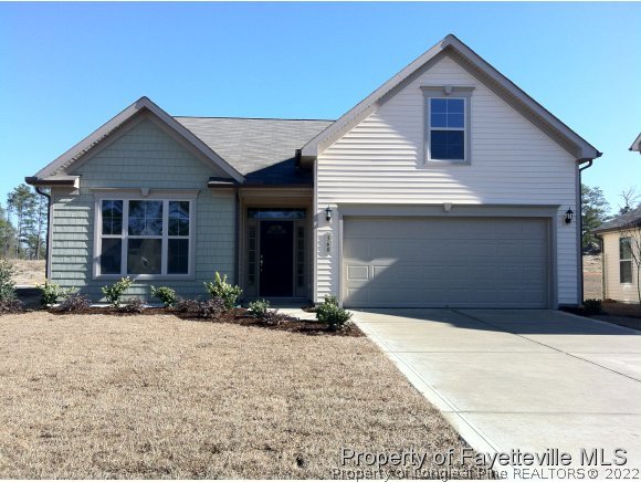 360 River Oak Street Spring Lake, NC 28390 - Photo 1 of 15 a front view of a house with a yard and garage