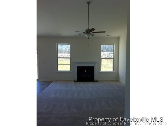 360 River Oak Street Spring Lake, NC 28390 - Photo 5 of 15 a view of a livingroom with a fireplace and a window