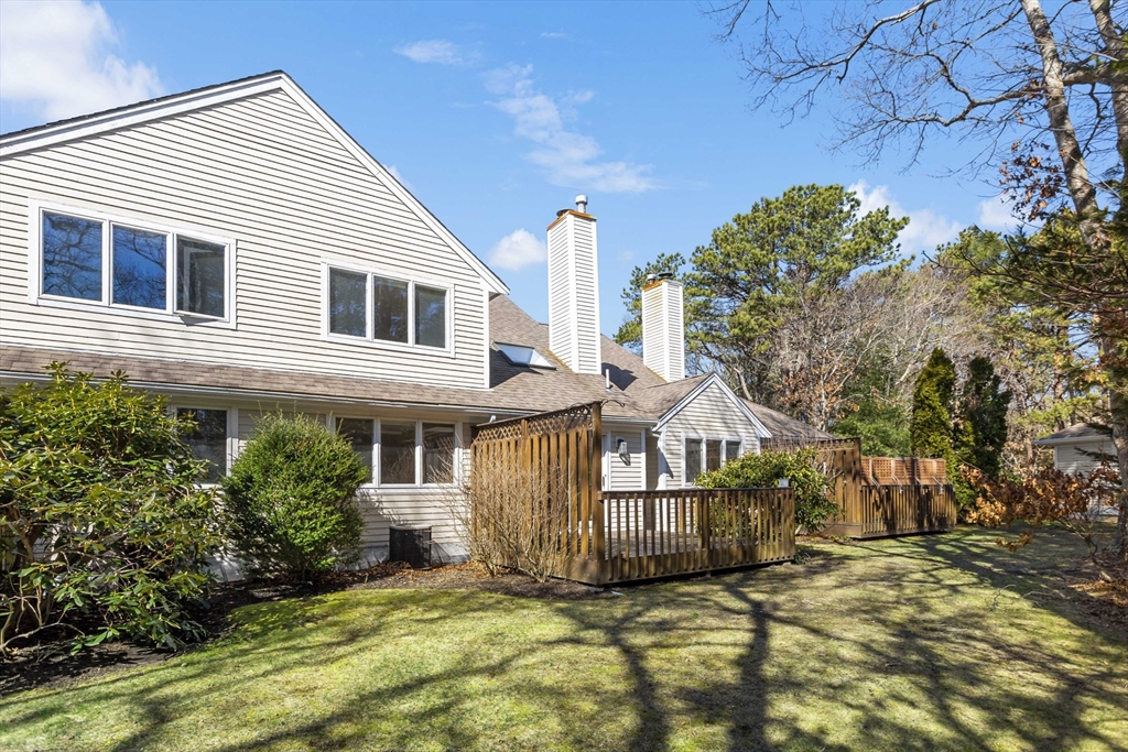 3 Kettle Lane, Unit 3 Mashpee, MA 02649 - Photo 21 of 24 a view of a house with a yard