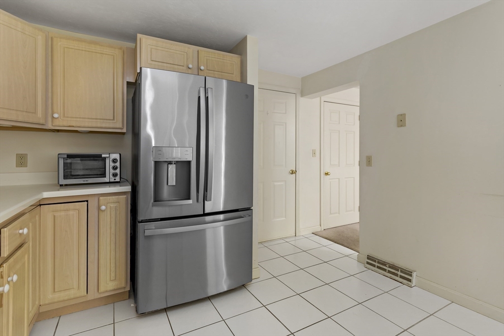 3 Kettle Lane, Unit 3 Mashpee, MA 02649 - Photo 7 of 24 a kitchen with stainless steel appliances a refrigerator and cabinets