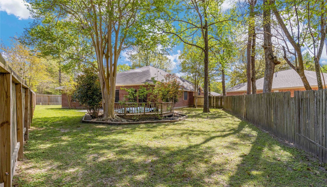 1707 Moston Drive Spring, TX 77386 - Photo 39 of 41 a view of a backyard with large trees