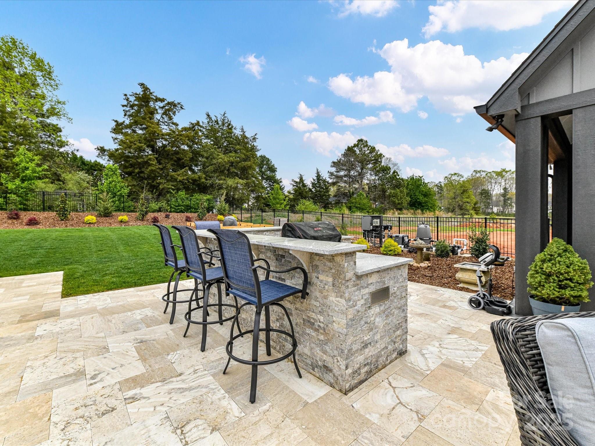 406 Sugar Maple Lane Weddington, NC 28104 - Photo 13 of 48 a view of a patio with a dining table and chairs with a patio