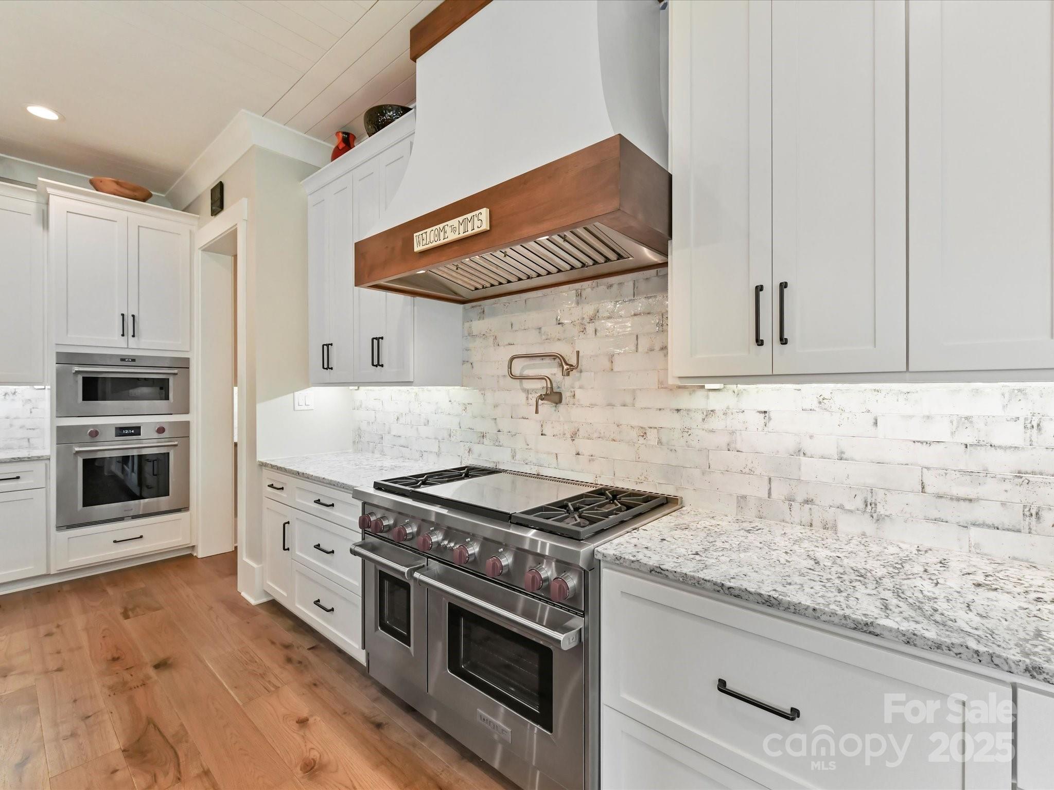 406 Sugar Maple Lane Weddington, NC 28104 - Photo 22 of 48 a kitchen with granite countertop a stove and a sink