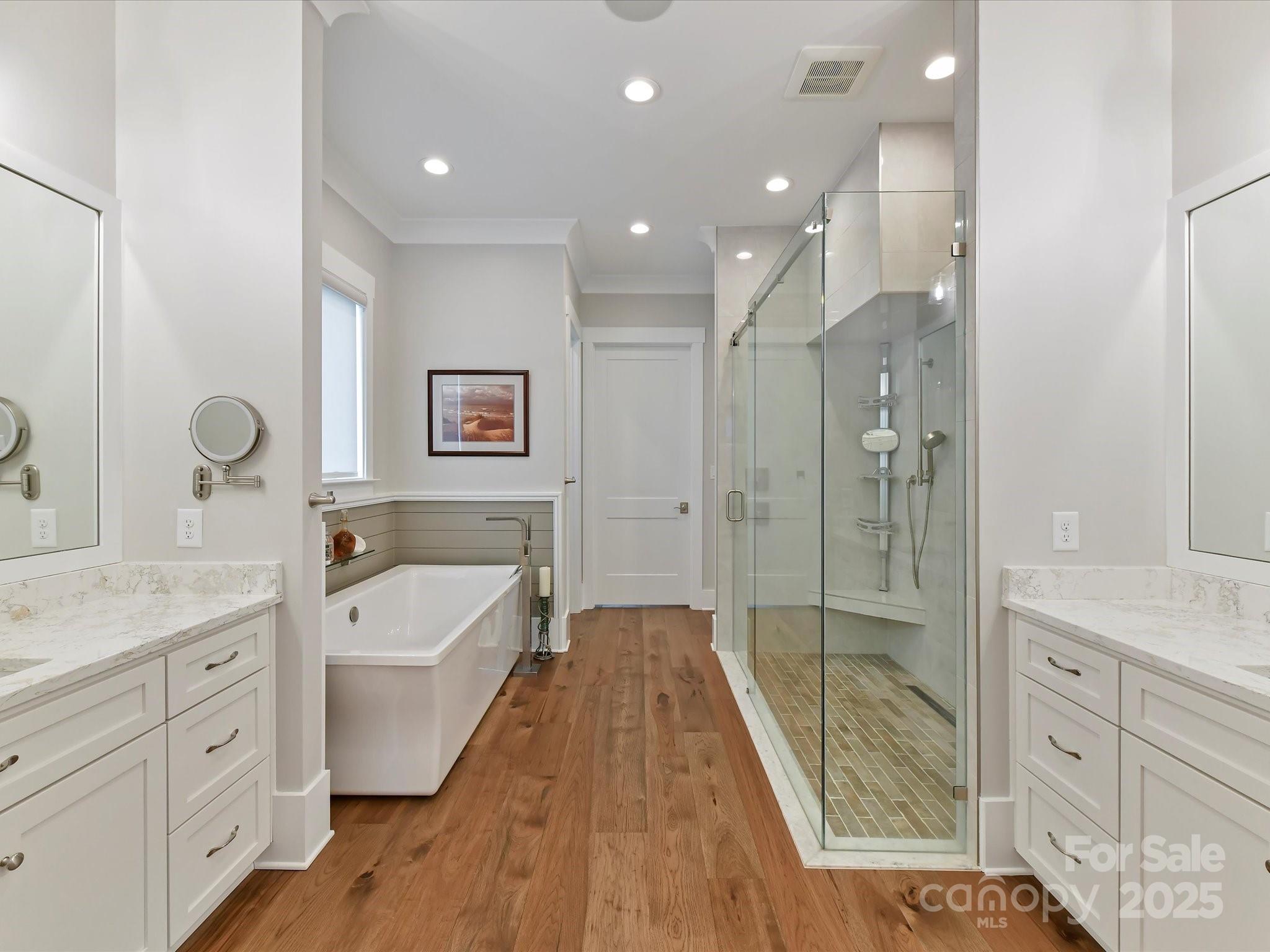 406 Sugar Maple Lane Weddington, NC 28104 - Photo 27 of 48 a spacious bathroom with a tub sink a mirror a vanity and shower