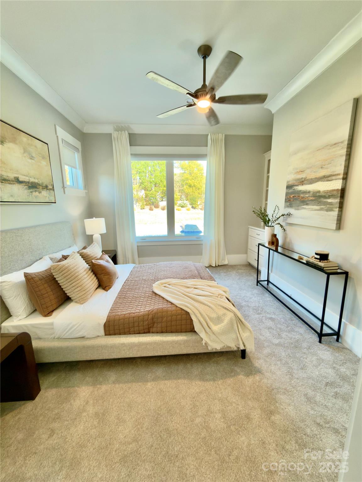 406 Sugar Maple Lane Weddington, NC 28104 - Photo 34 of 48 a bedroom with a bed and a chandelier