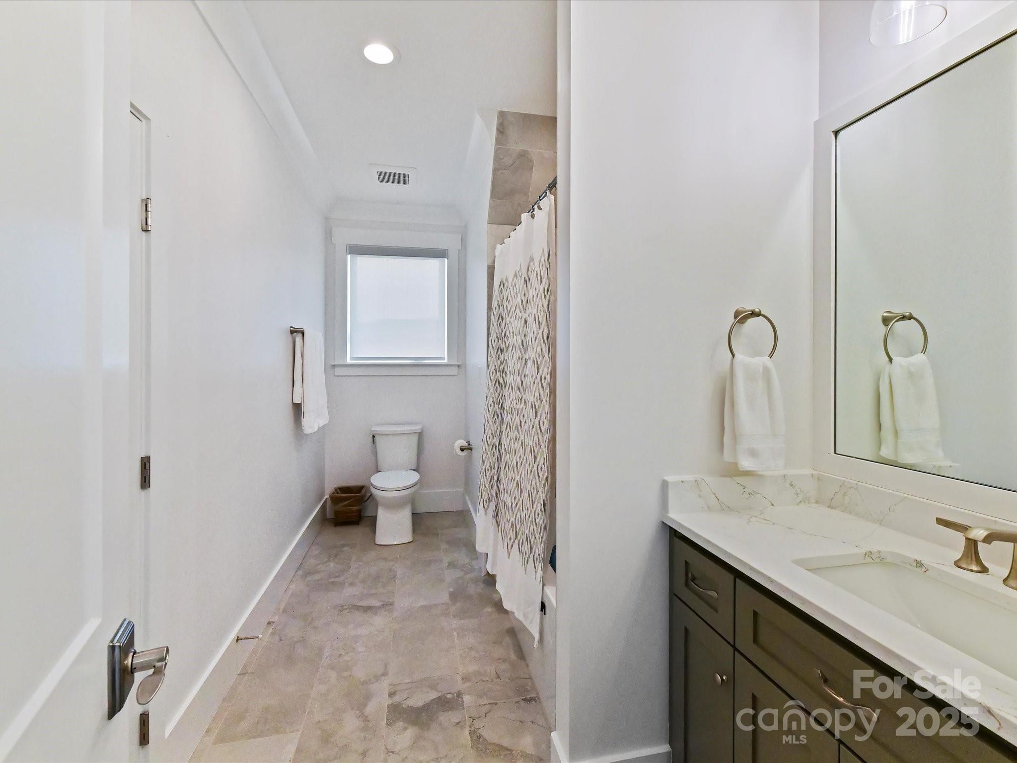 406 Sugar Maple Lane Weddington, NC 28104 - Photo 38 of 48 a bathroom with a sink and mirror with toilet