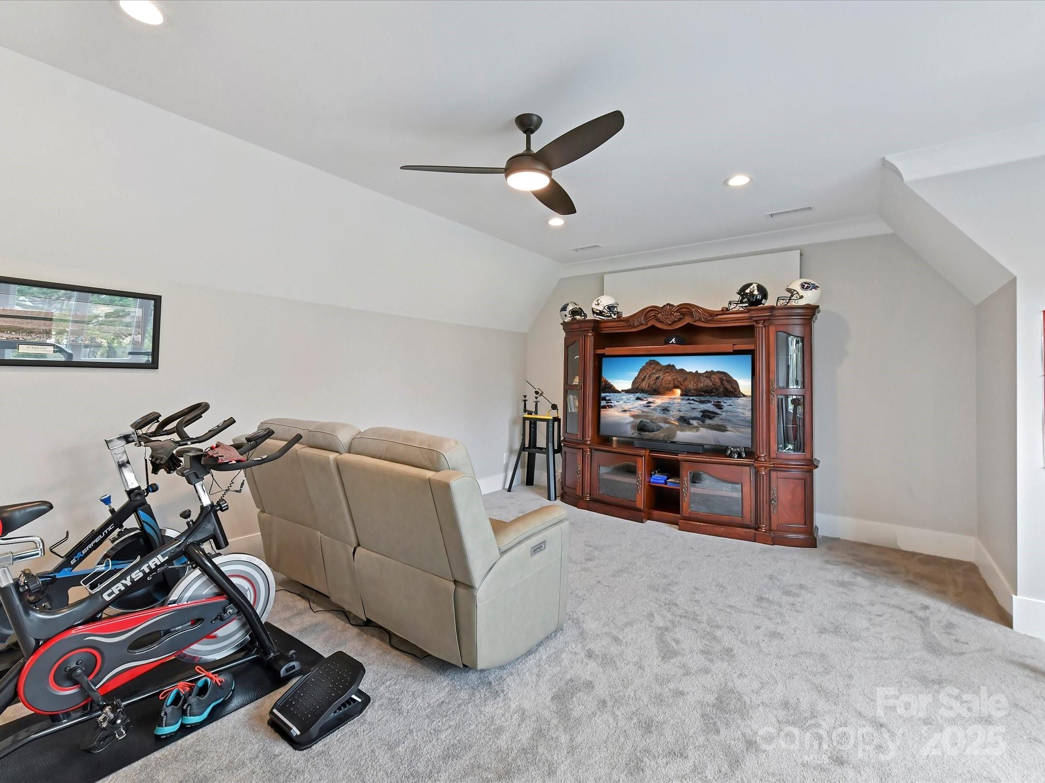 406 Sugar Maple Lane Weddington, NC 28104 - Photo 43 of 48 a living room with furniture gym equipment and a flat screen tv