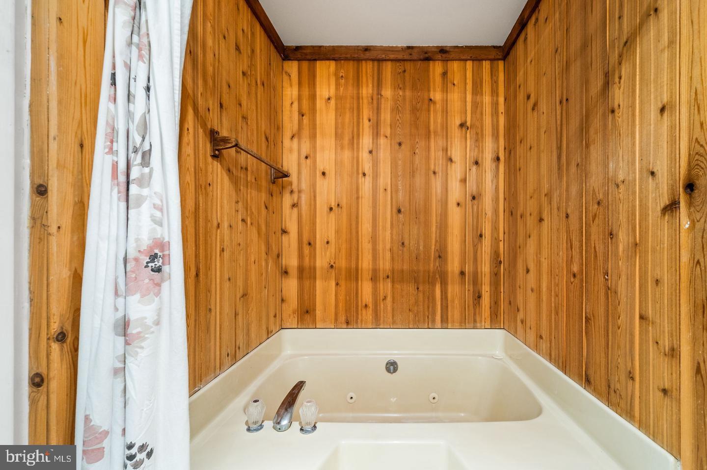 113 Spring Lane, Unit 7 West Chester, PA 19382 - Photo 13 of 18 a bathroom with a tub and shower curtain