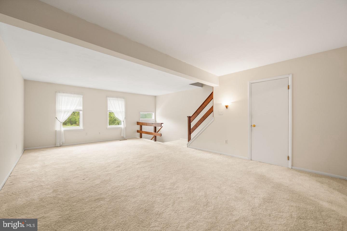 113 Spring Lane, Unit 7 West Chester, PA 19382 - Photo 3 of 18 a view of an empty room with wooden floor and a window
