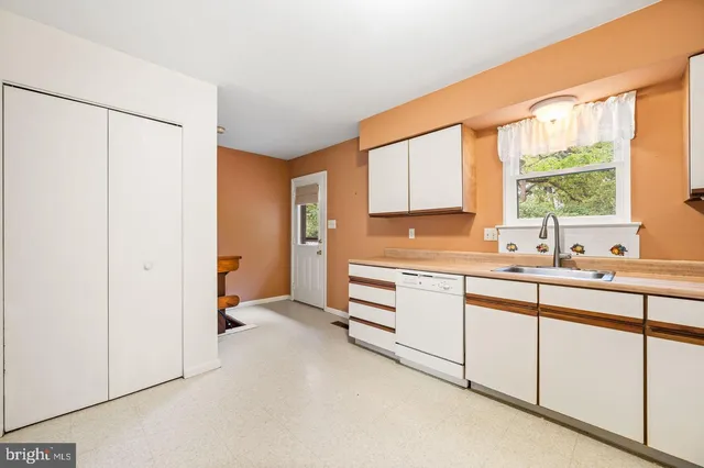 a kitchen with granite countertop a sink and a window