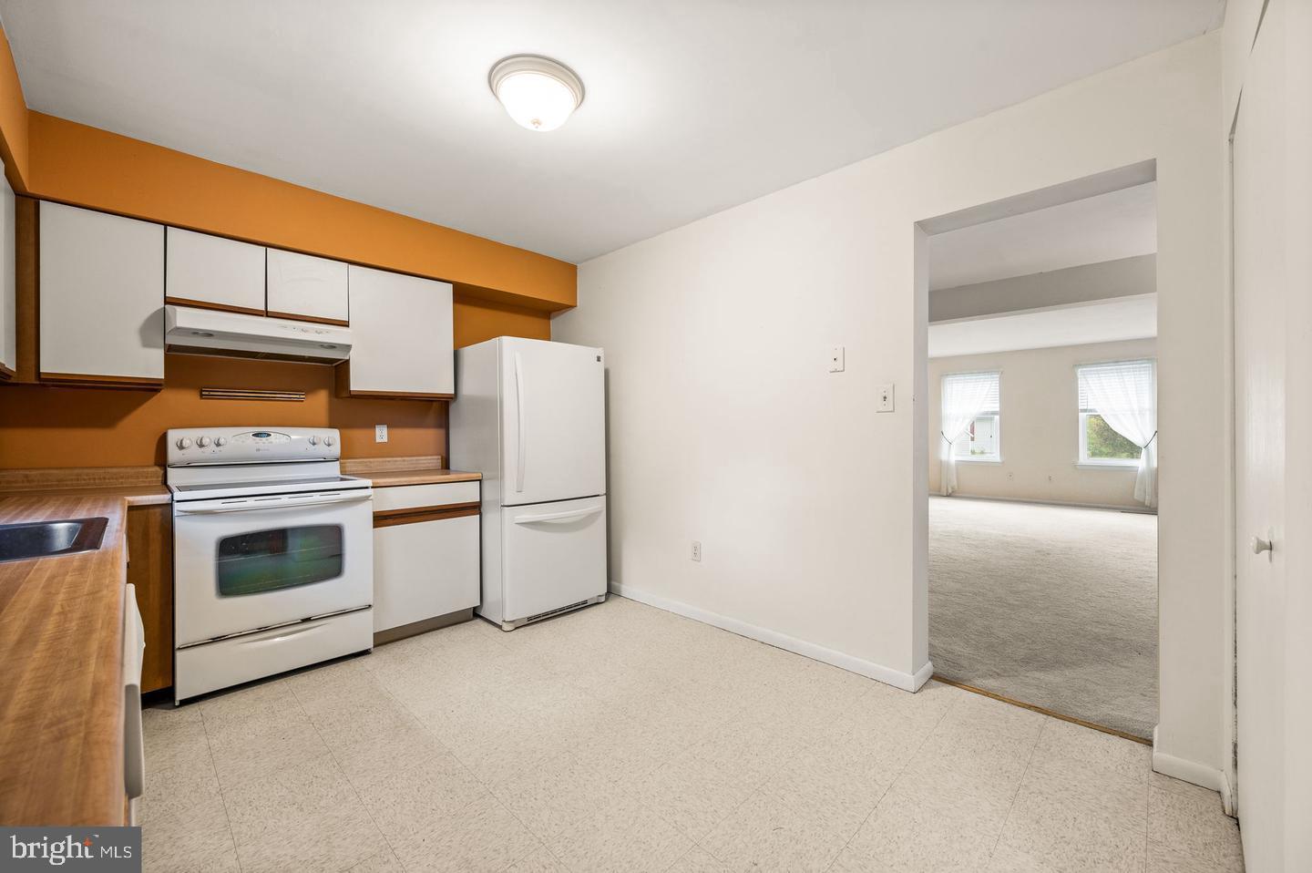 113 Spring Lane, Unit 7 West Chester, PA 19382 - Photo 7 of 18 a kitchen with stove and white cabinets