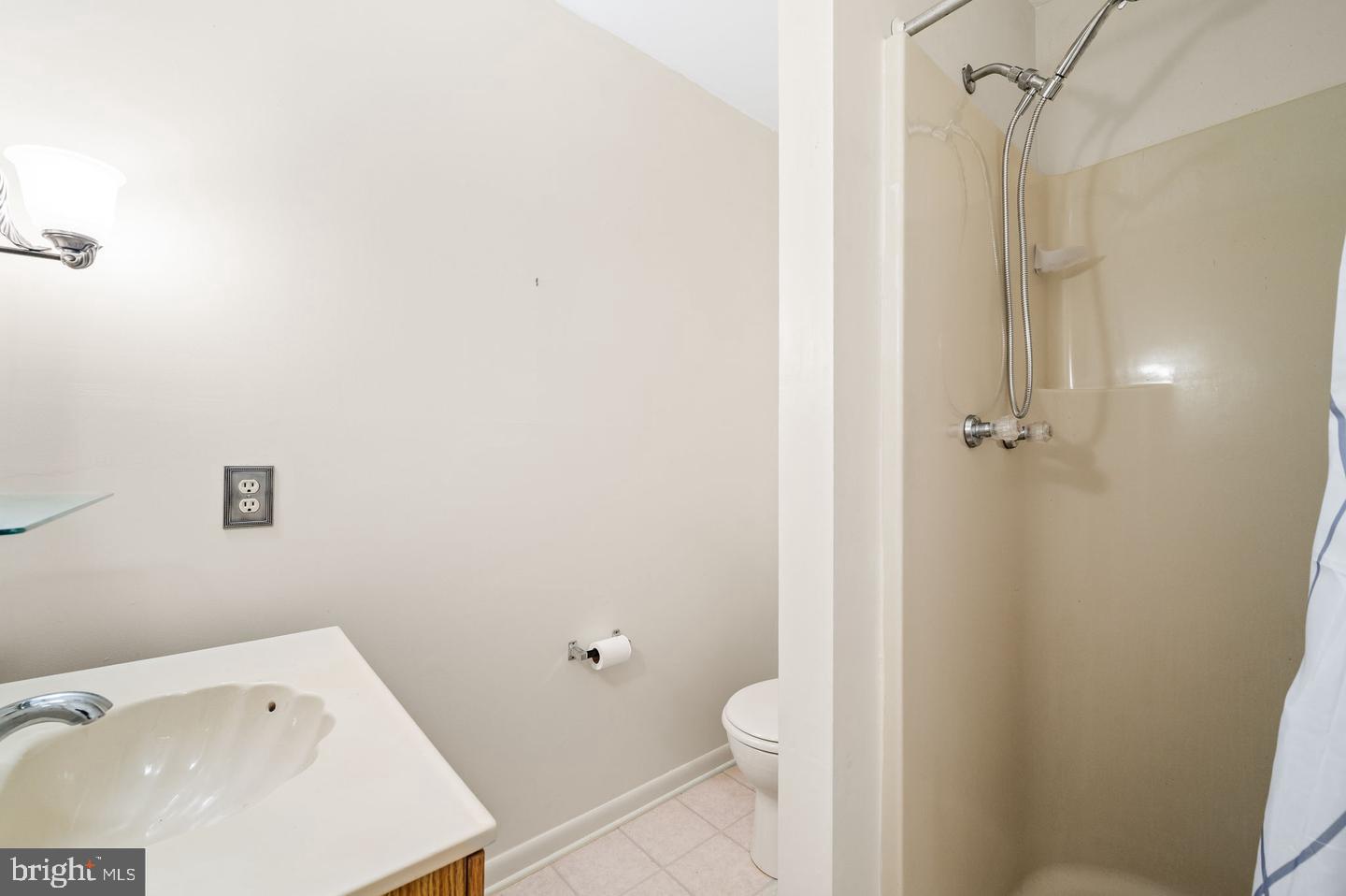 113 Spring Lane, Unit 7 West Chester, PA 19382 - Photo 10 of 18 a bathroom with a sink a toilet and shower