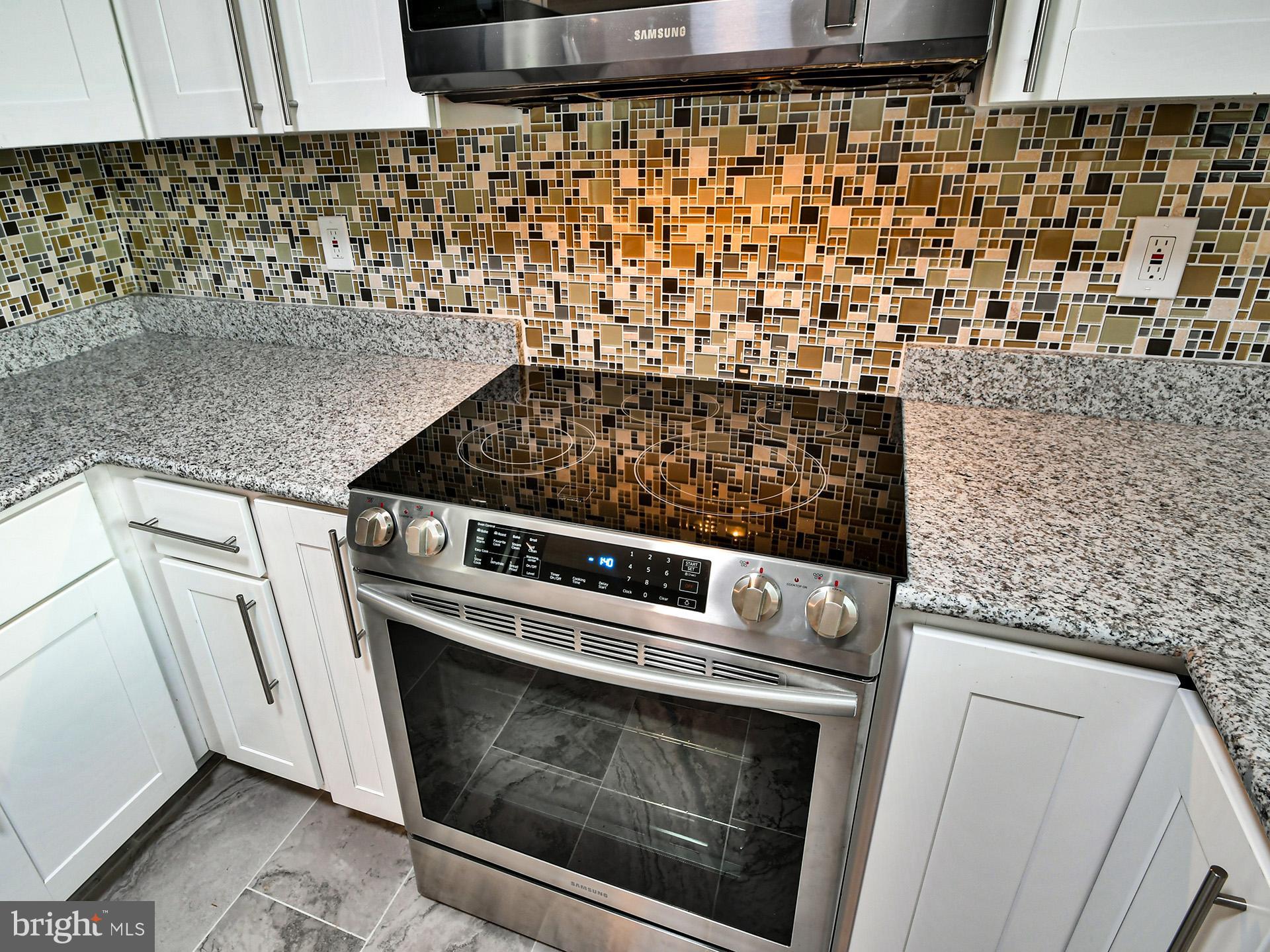 9303 Small Drive Clinton, MD 20735 - Photo 12 of 48 a close view of a stove top oven sitting inside of a kitchen
