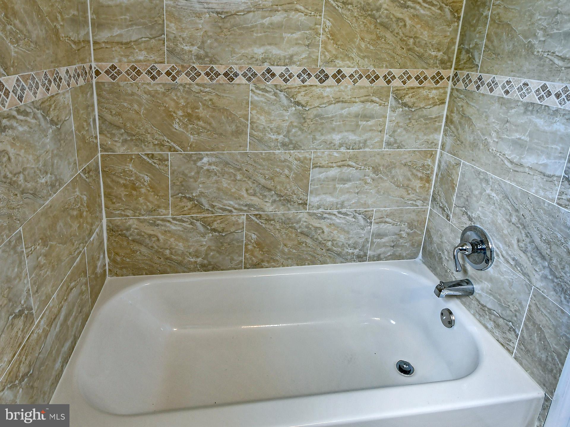 9303 Small Drive Clinton, MD 20735 - Photo 19 of 48 a bathroom with a bathtub