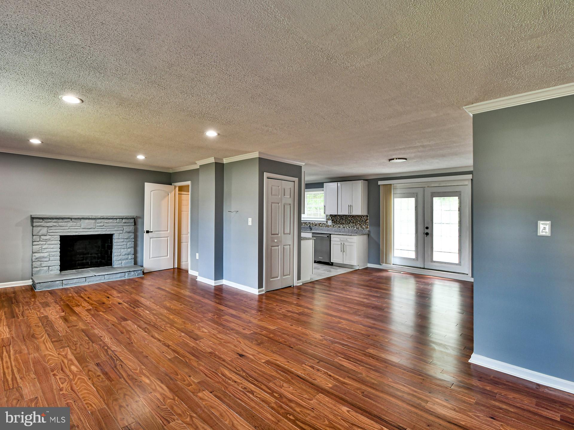 9303 Small Drive Clinton, MD 20735 - Photo 3 of 48 a view of an empty room with wooden floor fireplace and a window