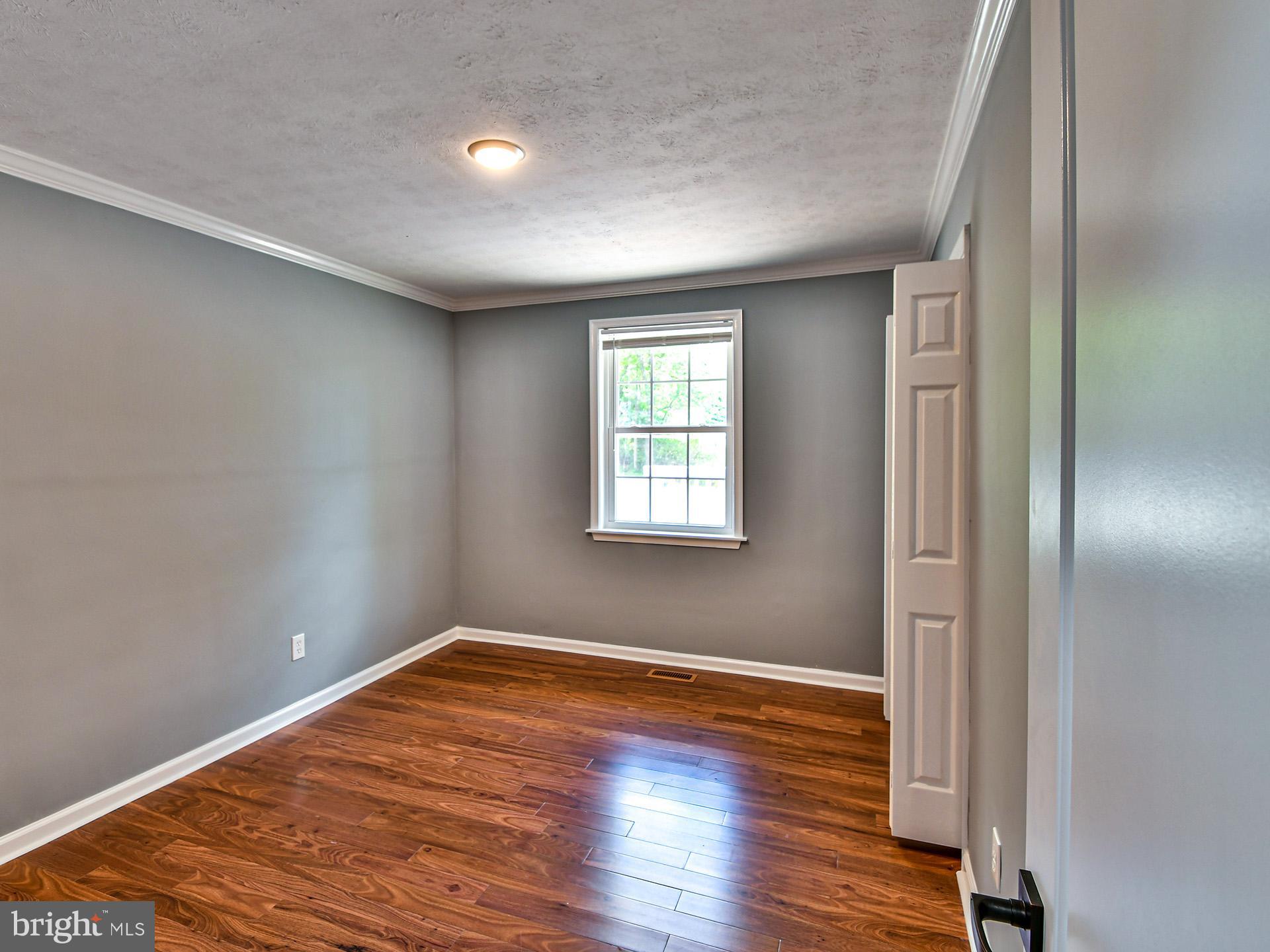 9303 Small Drive Clinton, MD 20735 - Photo 21 of 48 wooden floor in an empty room with a window