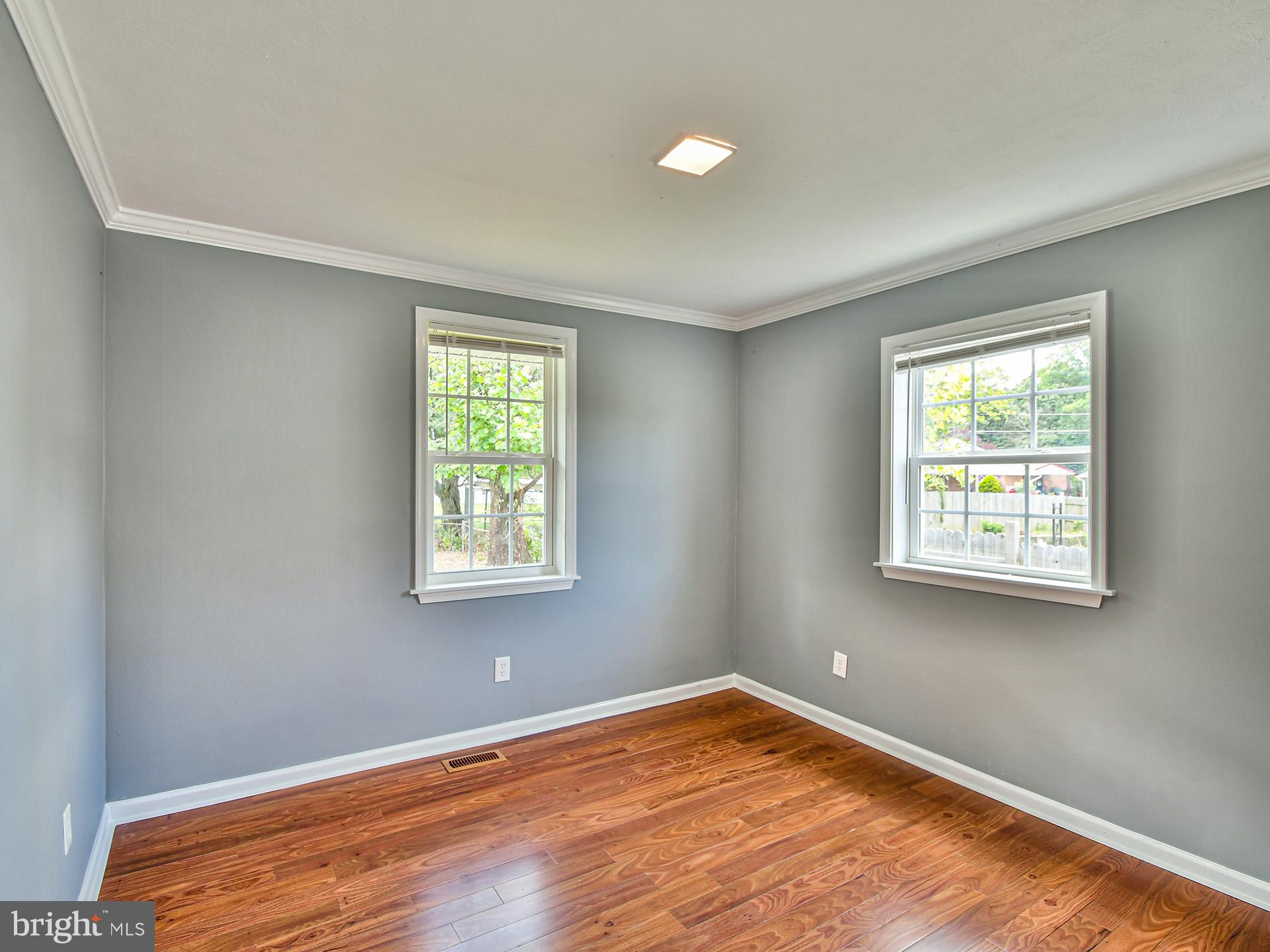 9303 Small Drive Clinton, MD 20735 - Photo 25 of 48 a view of an empty room with wooden floor and a window