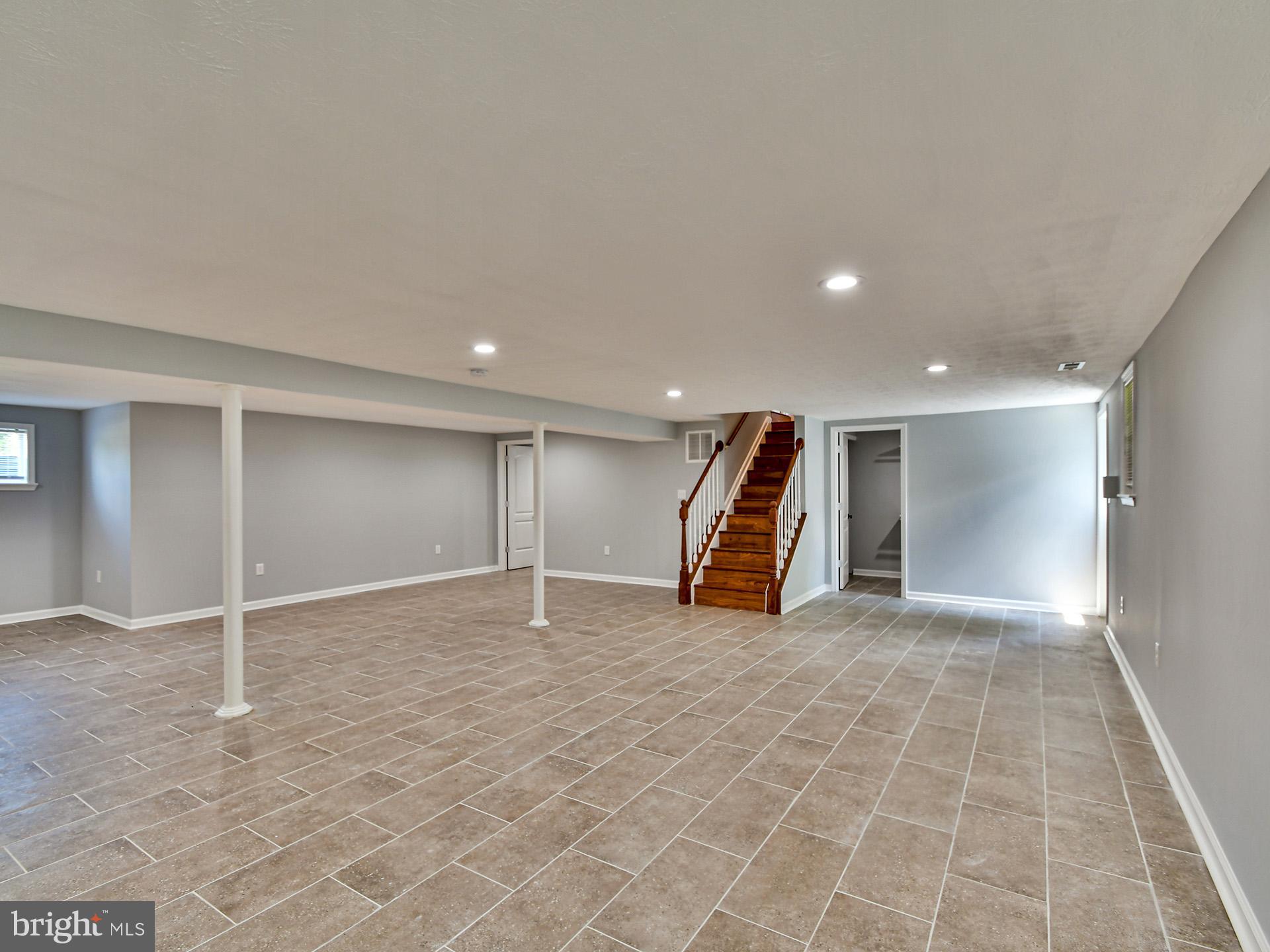 9303 Small Drive Clinton, MD 20735 - Photo 30 of 48 a view of a room with gym equipment and a projector