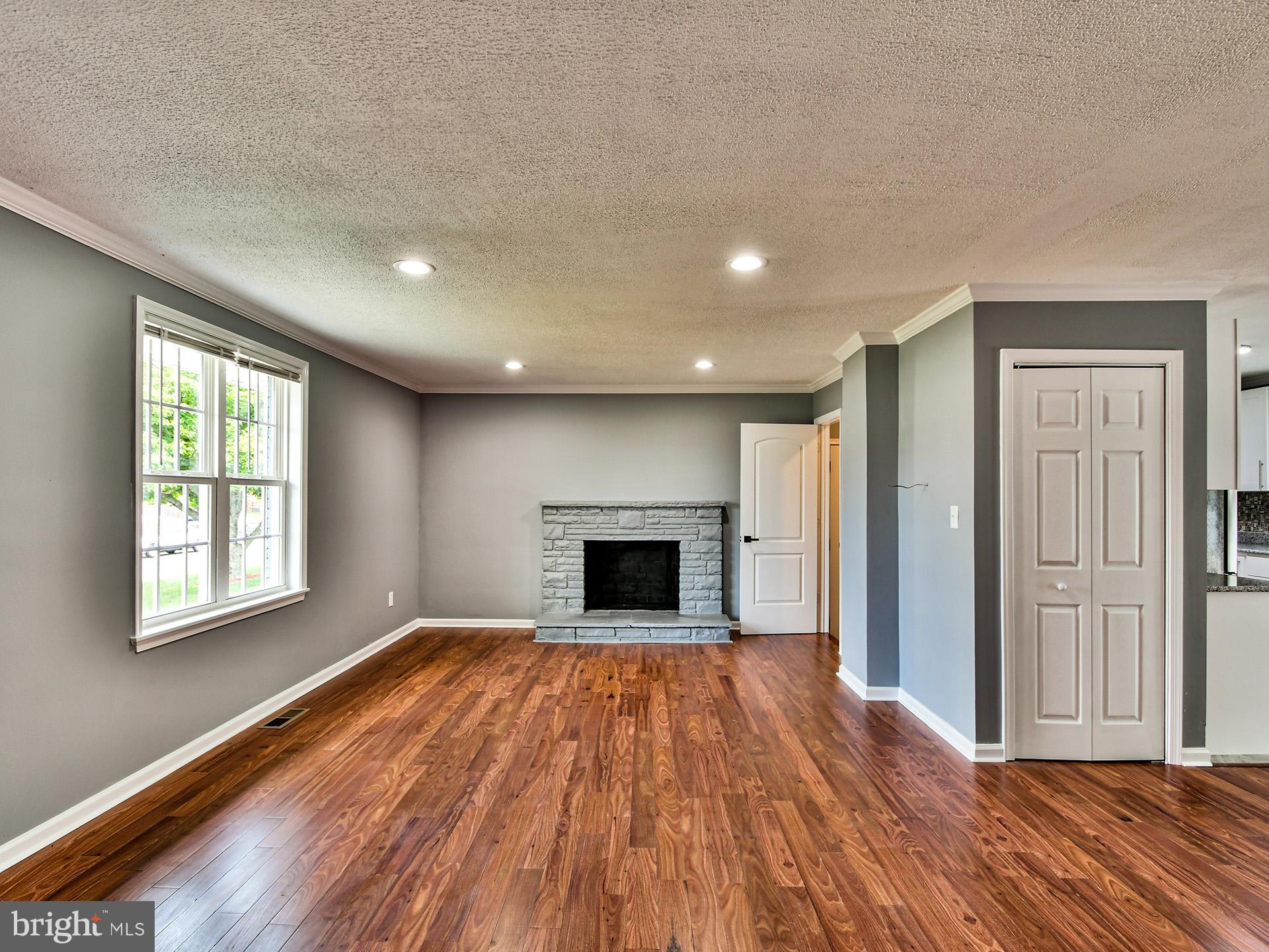 9303 Small Drive Clinton, MD 20735 - Photo 5 of 48 a view of a livingroom with wooden floor and fireplace