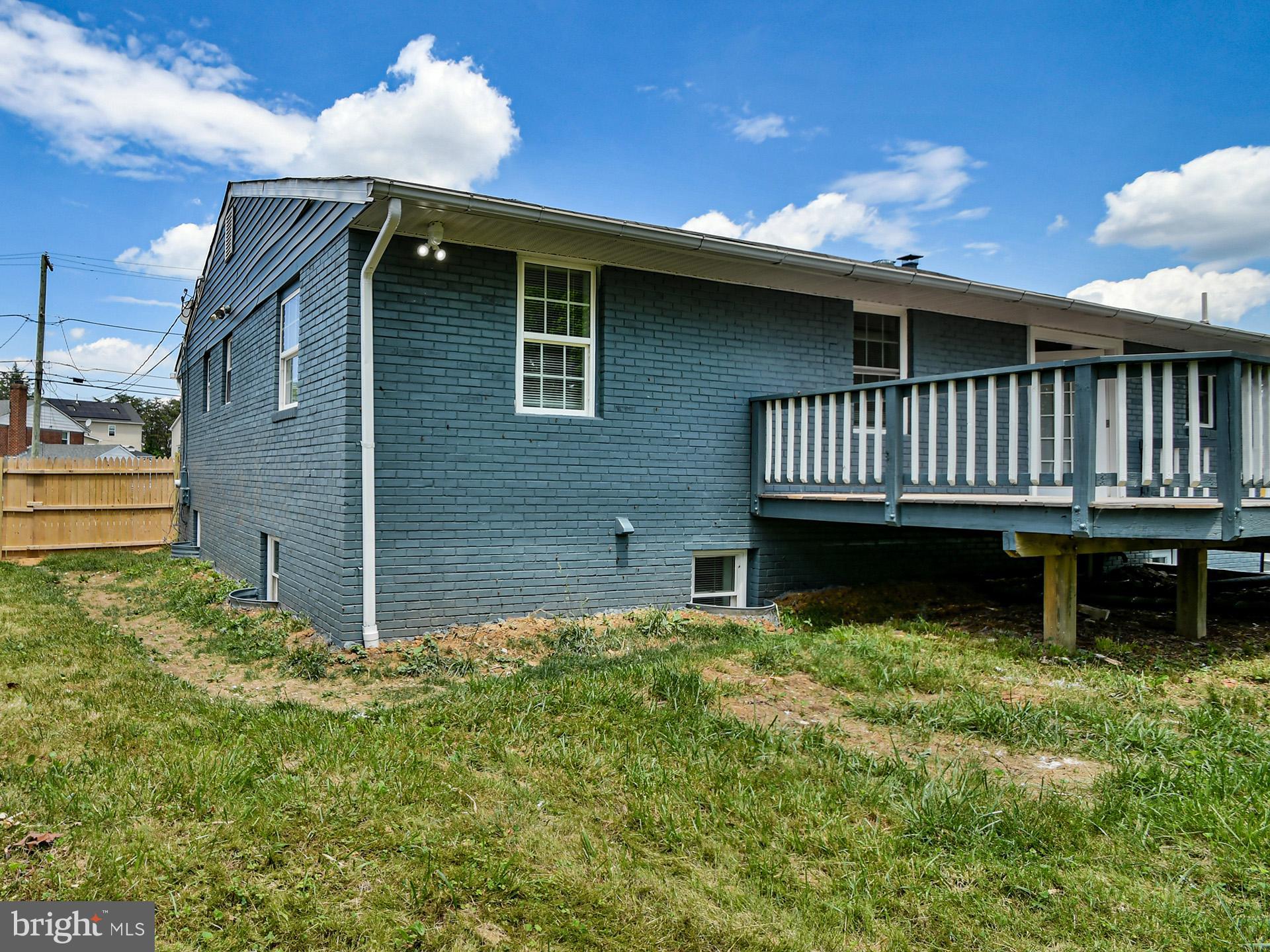9303 Small Drive Clinton, MD 20735 - Photo 47 of 48 a backyard of a house with deck and wooden floor