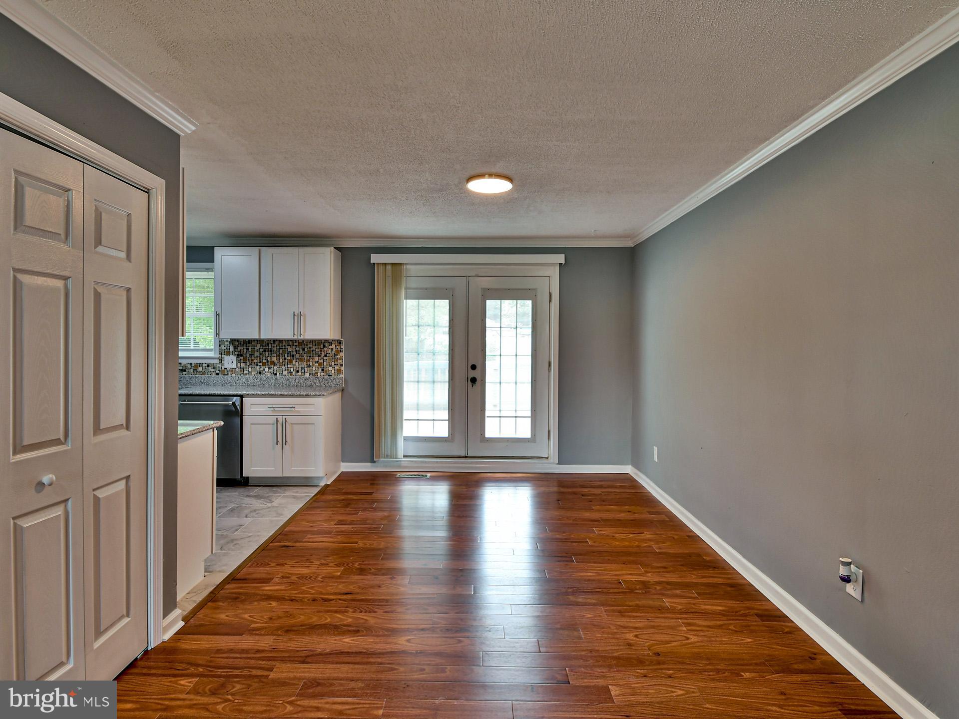 9303 Small Drive Clinton, MD 20735 - Photo 7 of 48 a view of a kitchen with a sink and wooden floor
