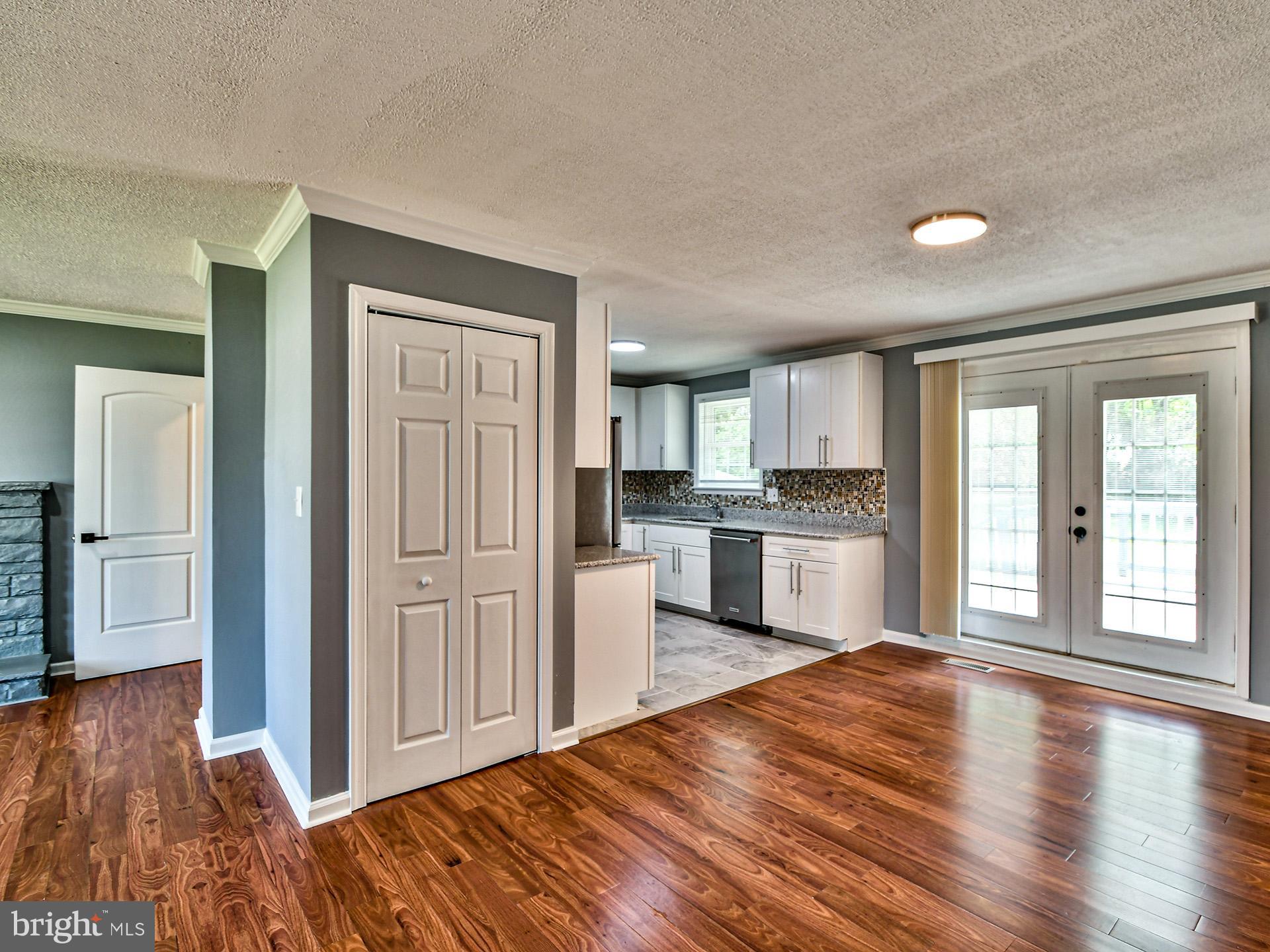 9303 Small Drive Clinton, MD 20735 - Photo 8 of 48 a open kitchen with white cabinets and wooden floor