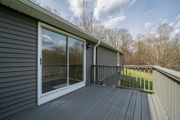 a view of balcony with wooden floor and fence