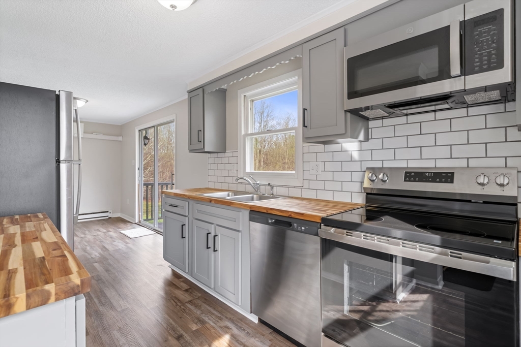 67 Bromley Road Huntington, MA 01050 - Photo 15 of 34 a kitchen with stainless steel appliances stove microwave refrigerator and cabinets