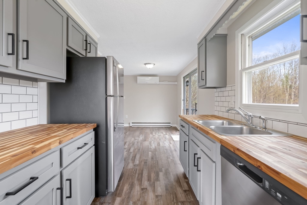 67 Bromley Road Huntington, MA 01050 - Photo 16 of 34 a kitchen with granite countertop a sink stove and cabinets