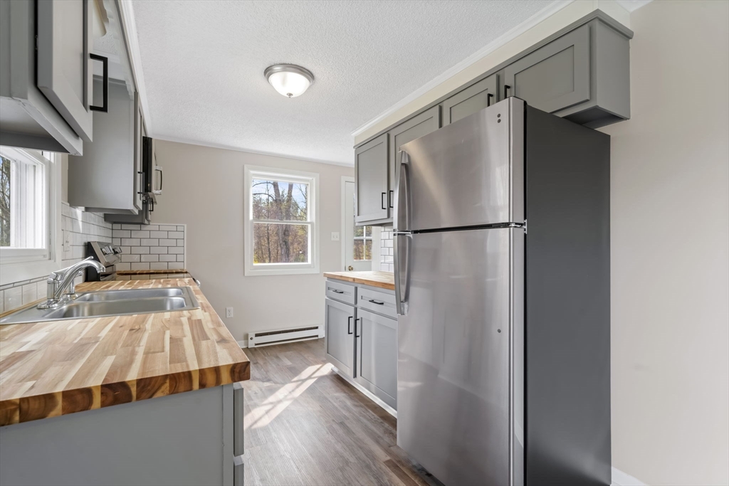 67 Bromley Road Huntington, MA 01050 - Photo 18 of 34 a bedroom with a bed and a refrigerator