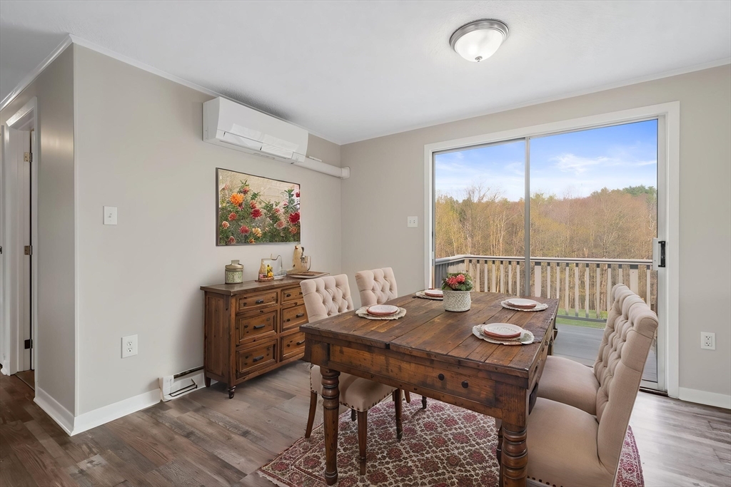 67 Bromley Road Huntington, MA 01050 - Photo 19 of 34 a view of a dining room with furniture large window and wooden floor