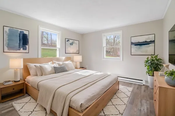 a bedroom with a bed and a potted plant