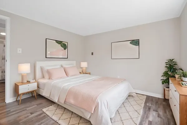 a bedroom with bed and a potted plant