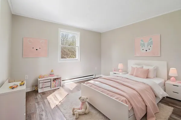 a bedroom with a bed and a potted plant