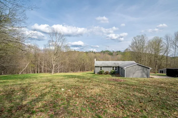 a view of a house with a yard