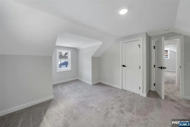 a view of white house that has a tree in the background