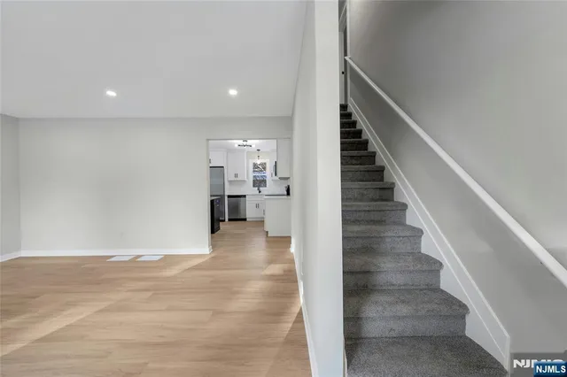 a view of entryway and hall with wooden floor