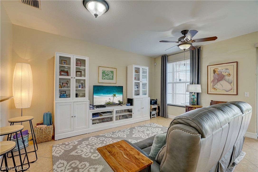 4089 Cherrybrook Loop Fort Myers, FL 33966 - Photo 11 of 35 a living room with furniture and a flat screen tv