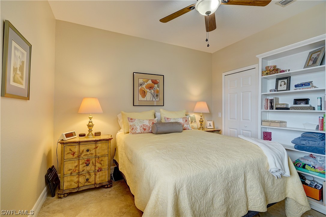 4089 Cherrybrook Loop Fort Myers, FL 33966 - Photo 21 of 35 a bedroom with a bed and a lamp on the dresser