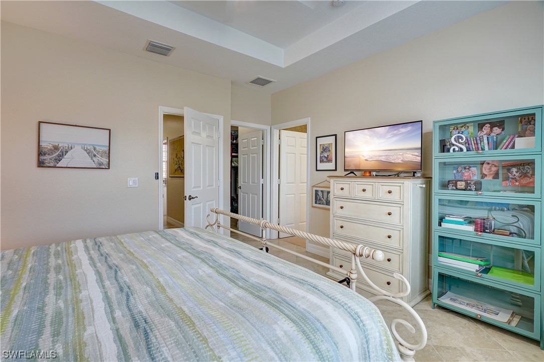 4089 Cherrybrook Loop Fort Myers, FL 33966 - Photo 27 of 35 a bedroom with a bed and a flat screen tv