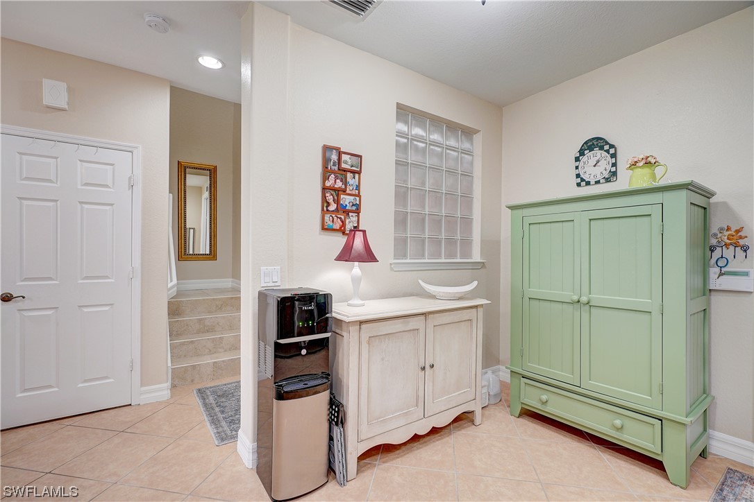 4089 Cherrybrook Loop Fort Myers, FL 33966 - Photo 28 of 35 a kitchen with white cabinets and a refrigerator