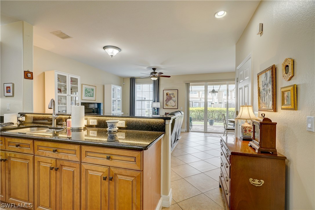 4089 Cherrybrook Loop Fort Myers, FL 33966 - Photo 9 of 35 a large living room with stainless steel appliances granite countertop a sink a stove and a refrigerator