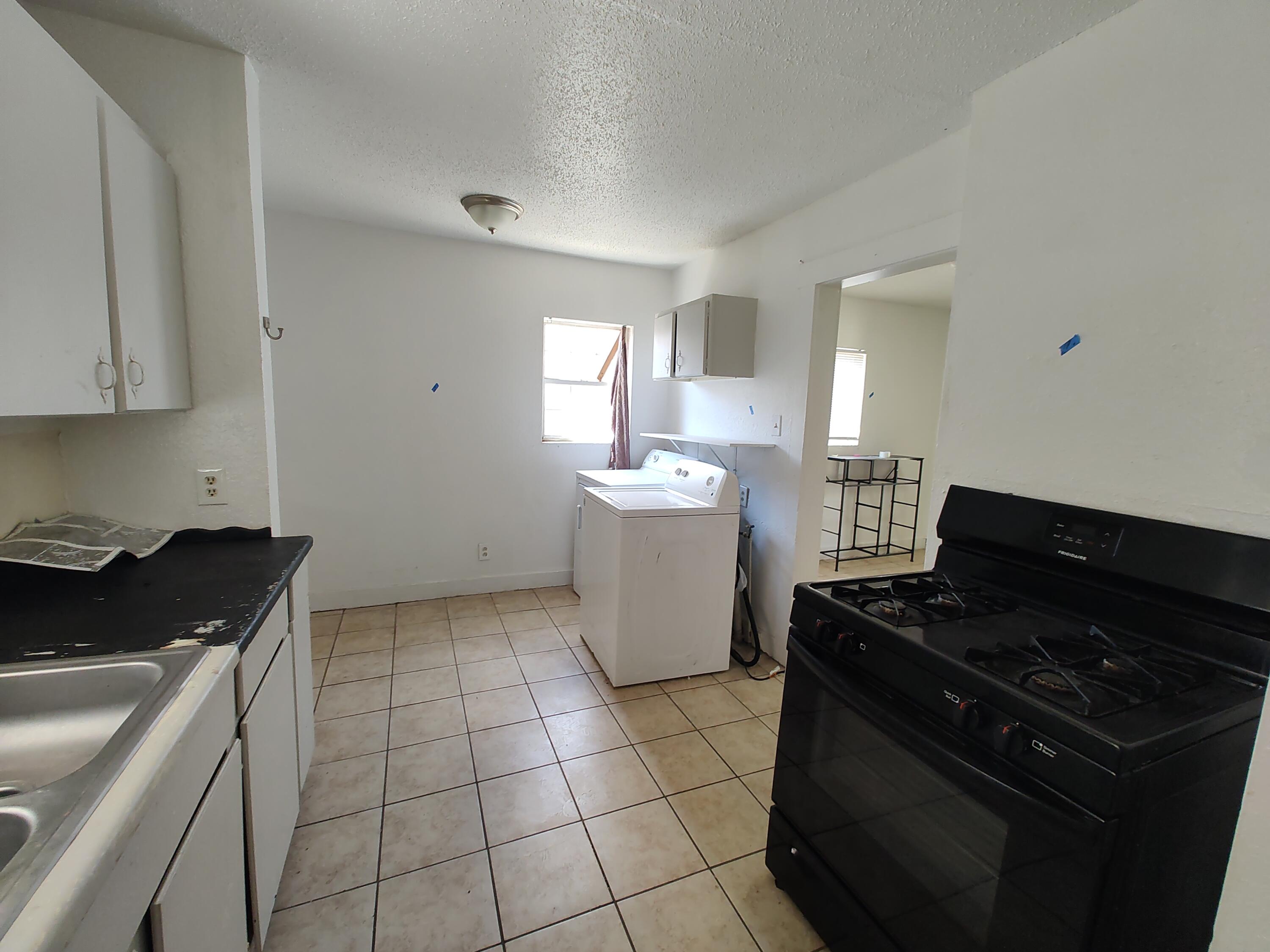 1803 49th Street Lubbock, TX 79412 - Photo 7 of 12 a kitchen that has a sink and a stove
