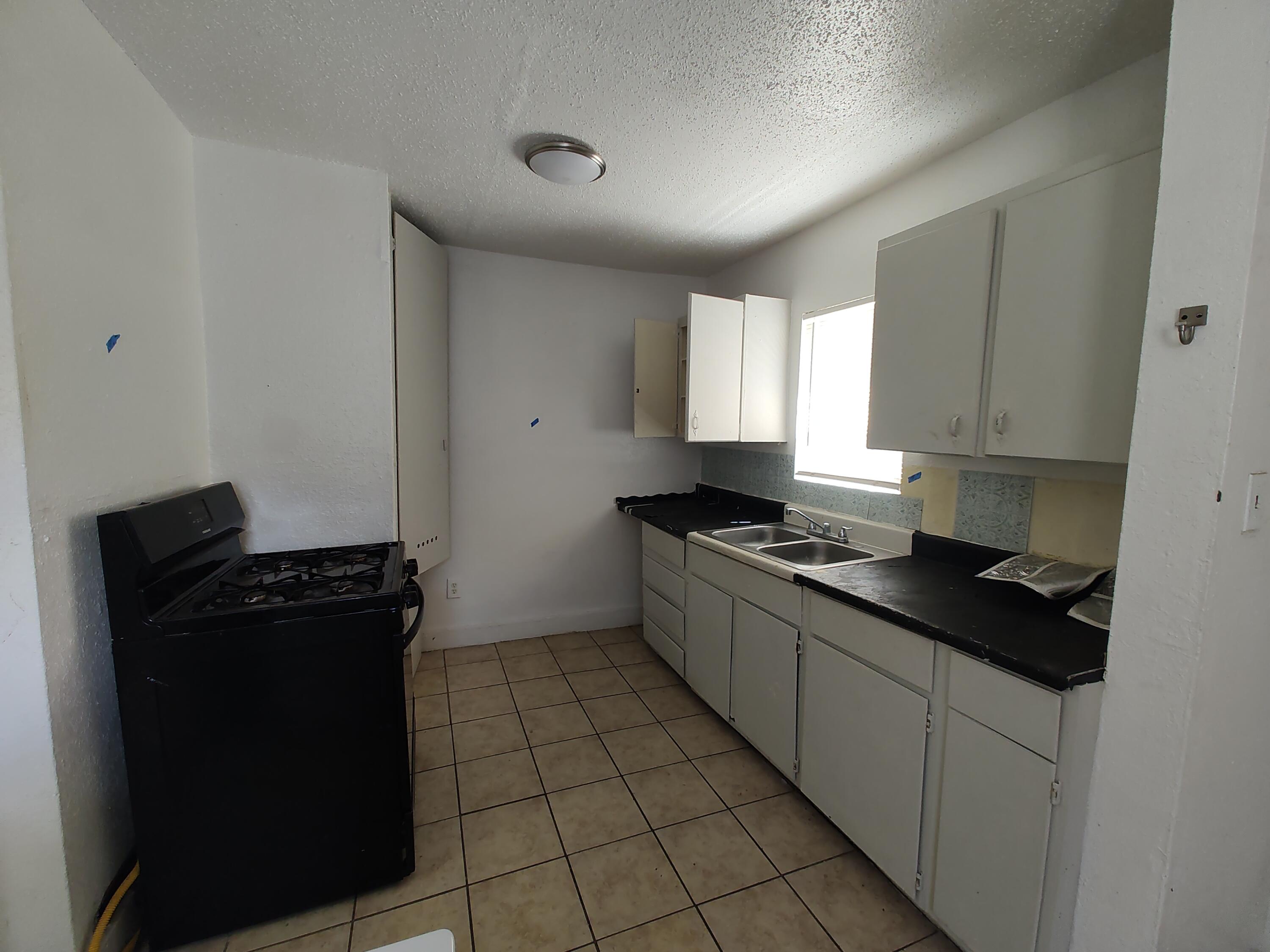 1803 49th Street Lubbock, TX 79412 - Photo 8 of 12 a kitchen with a refrigerator and a stove