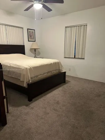 a spacious bedroom with a bed and a chandelier