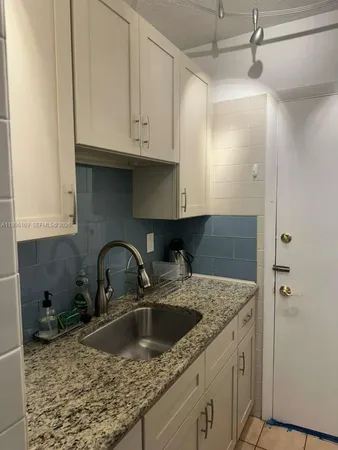 a kitchen with a sink and cabinets