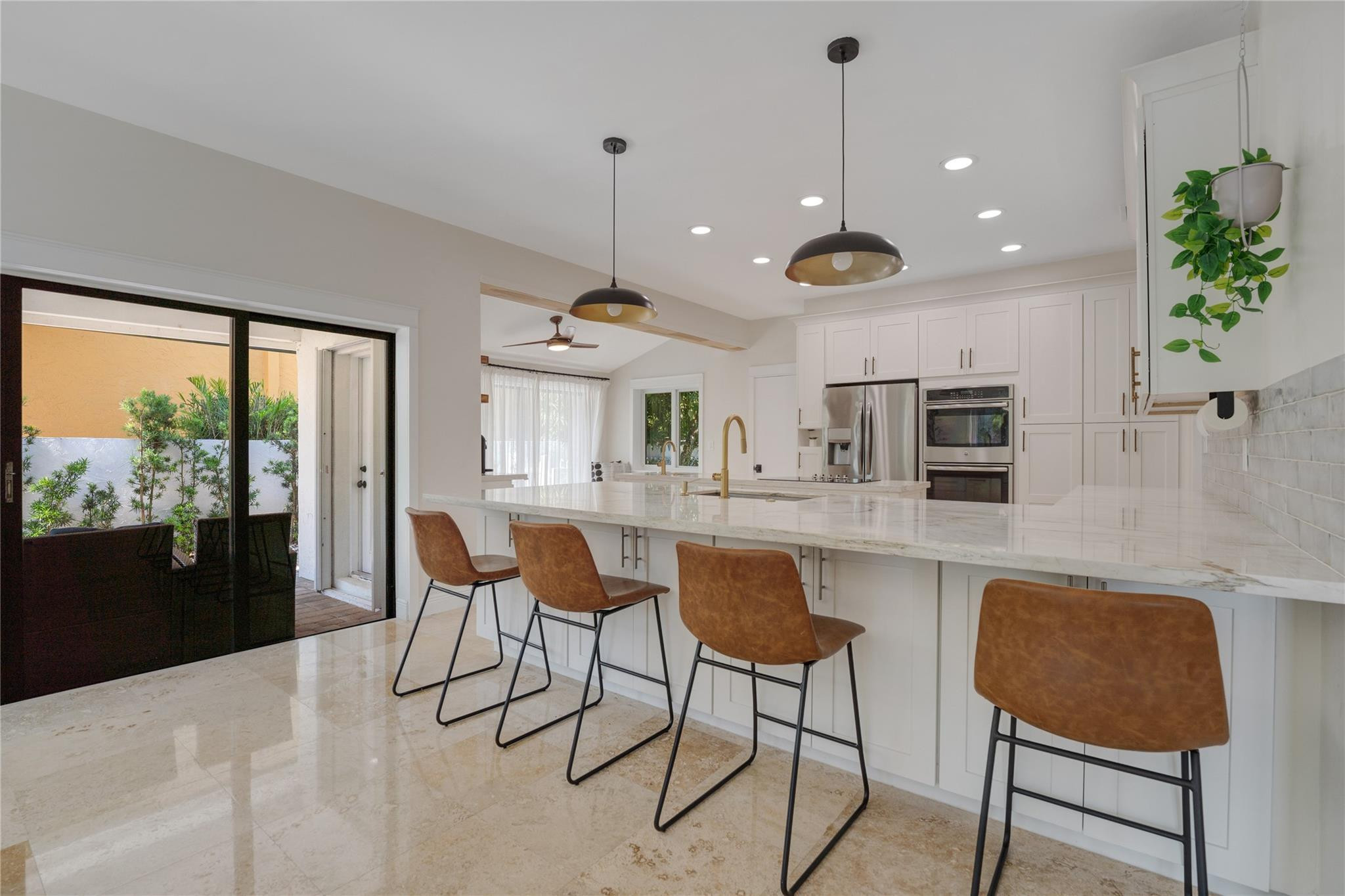 741 Mockingbird Lane Plantation, FL 33324 - Photo 3 of 59 a kitchen with stainless steel appliances granite countertop table chairs and a large window