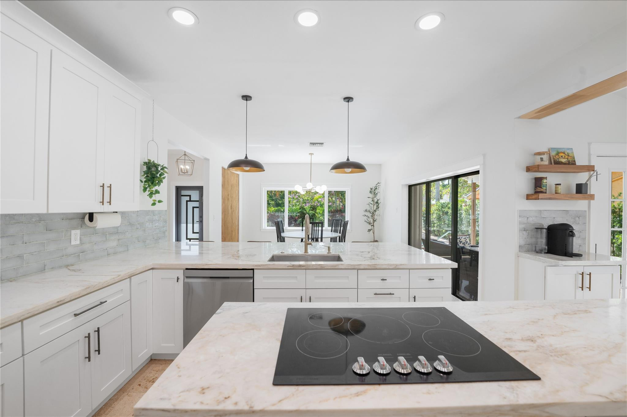 741 Mockingbird Lane Plantation, FL 33324 - Photo 8 of 59 a large kitchen with kitchen island white cabinets and stainless steel appliances